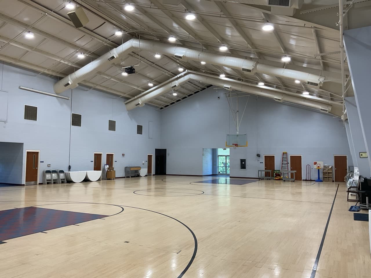 School gymnasium with bright LED high-bay lighting after DTL upgrade