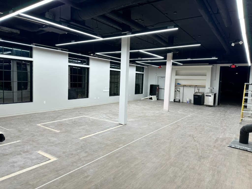 Modern commercial interior with linear LED strip lighting on black ceiling