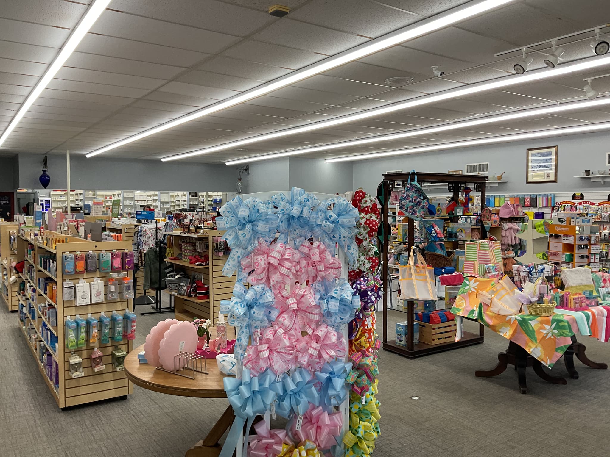Same retail pharmacy with bright LED linear strip lighting providing uniform white illumination